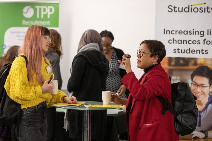 two women chatting and networking at an event