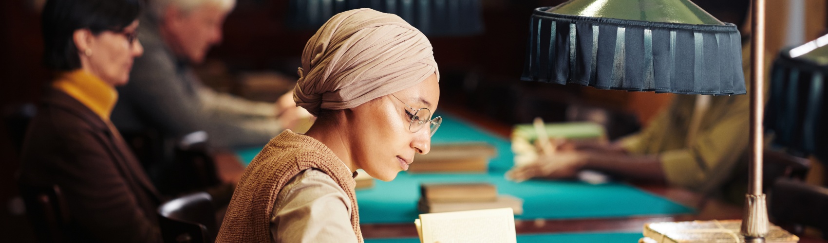 A young Muslim woman studies in a classic library