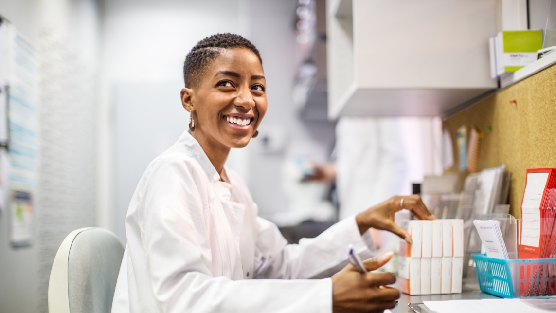 Smiling chemist working at desk