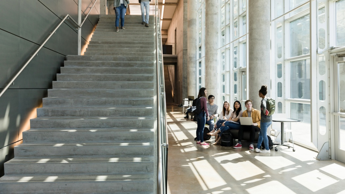 College students descend indoor staircase