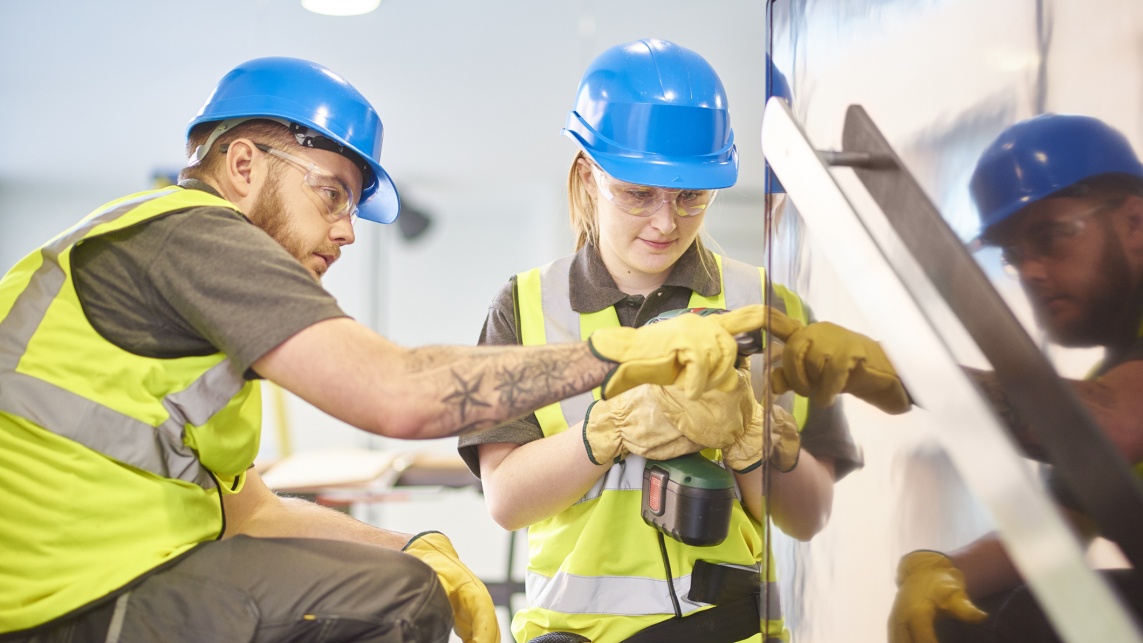 female construction apprentice and colleague