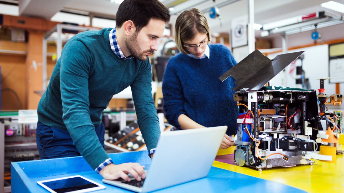 Young students of robotics working on project 