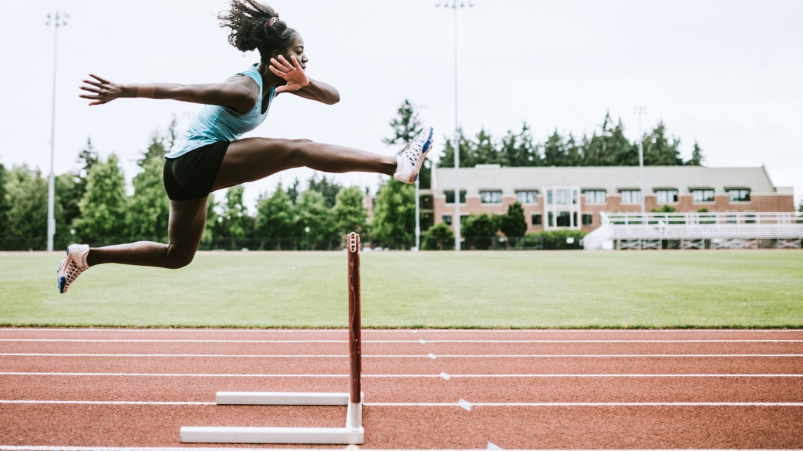 Woman Athlete Runs Hurdles for Track and Field