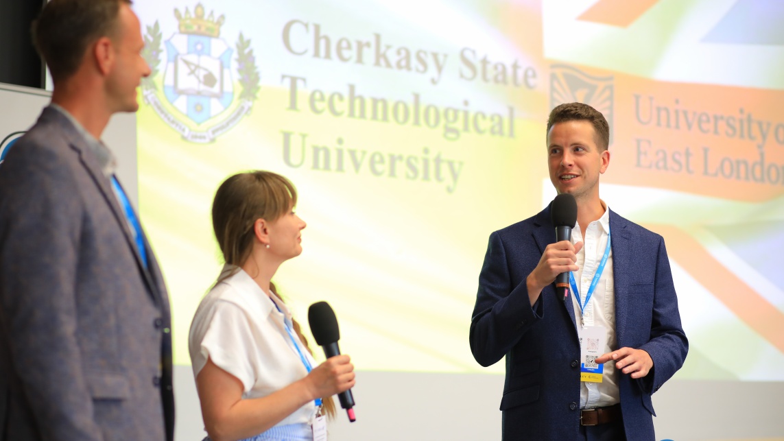 1.	Emil Faure, Liudmyla Usyk (ChSTU) & Sam Jelliman (UEL), left to right, present the project at the Twinning conference in Warsaw