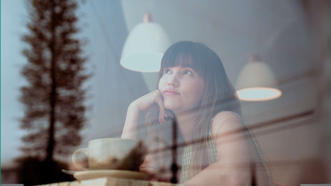 a girl that is looking out the window