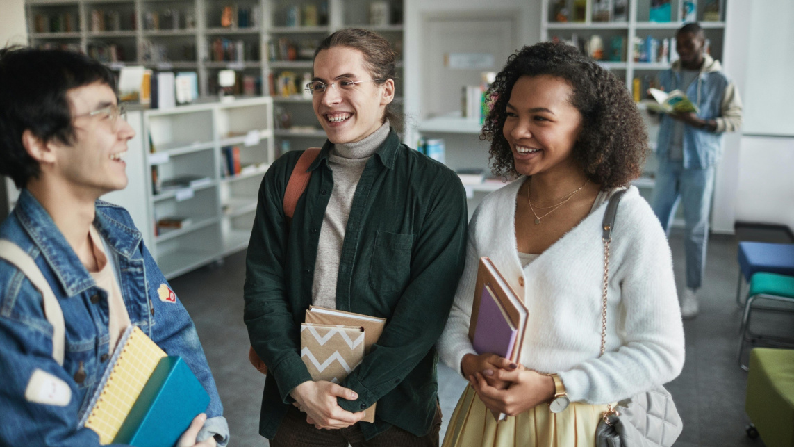 Students talking and smiling in a communal study area