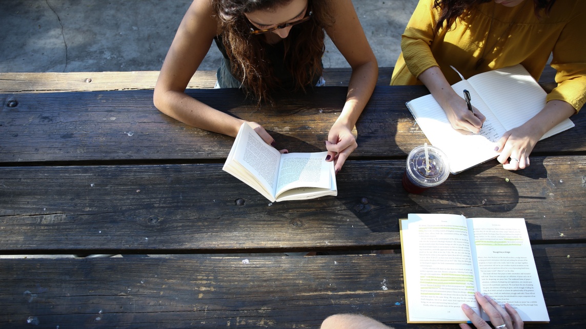 Students working on a park bench