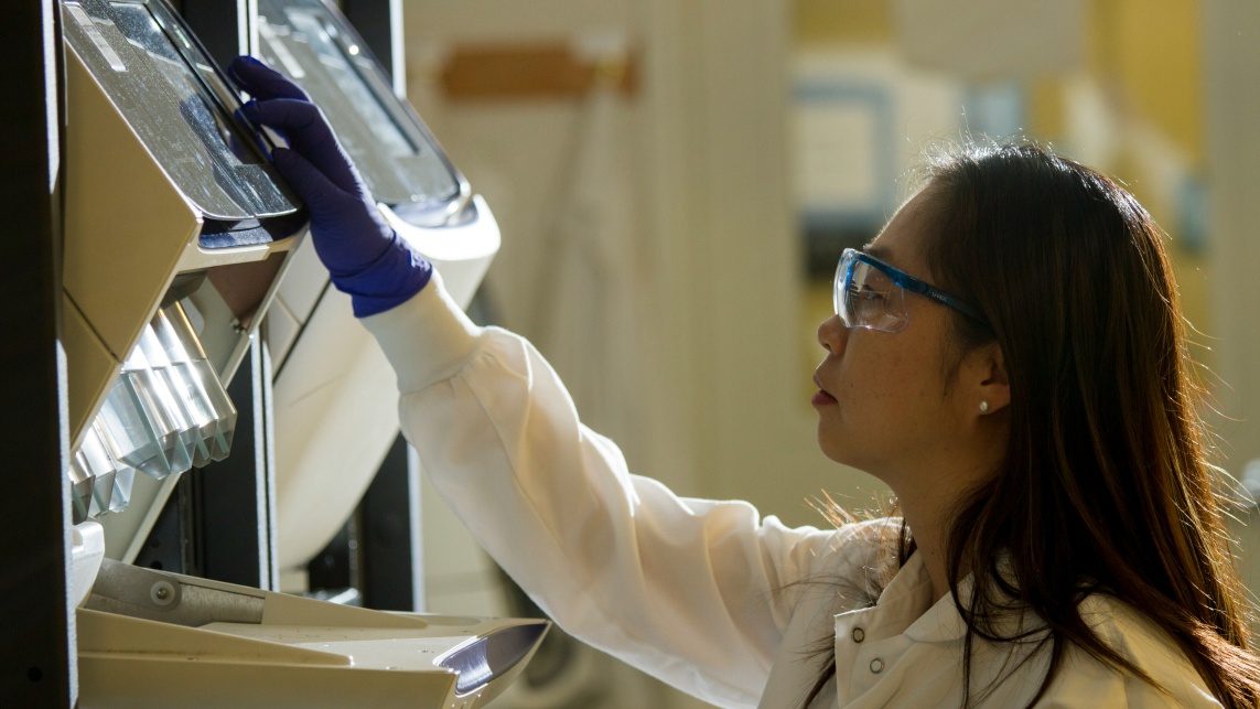 A scientists working on a machine