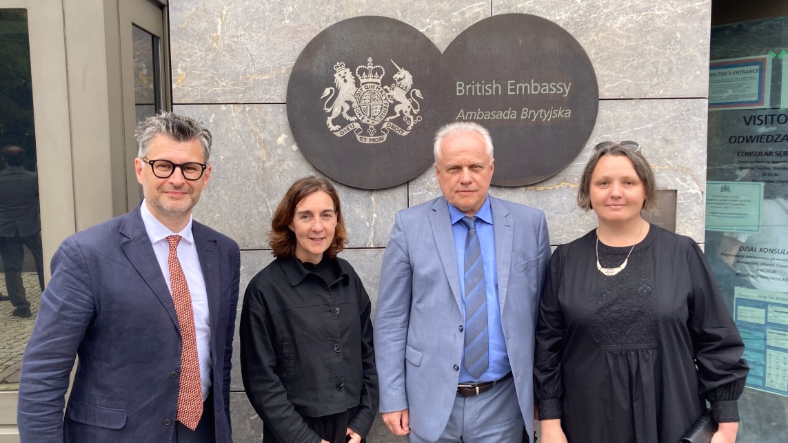 Four colleagues standing in front of the British Embassy in Ukraine.