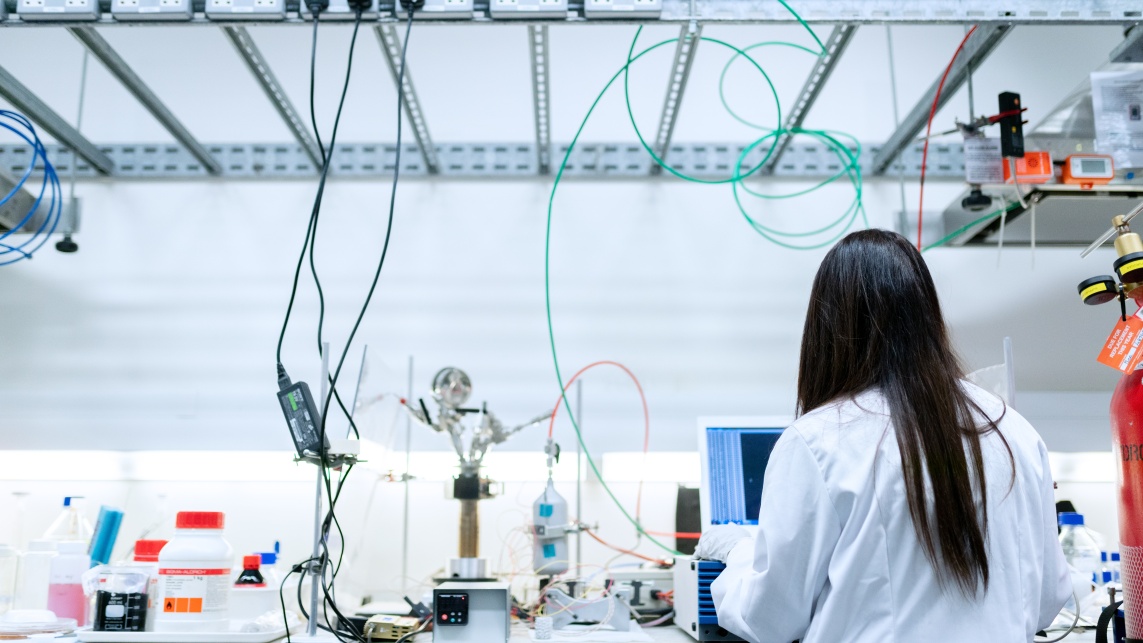 A person facing a screen in a laboratory