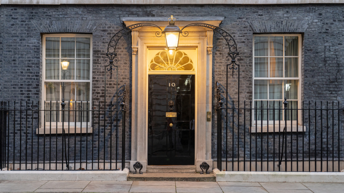 10 Downing Street door and windows with the overhead light on above the door.