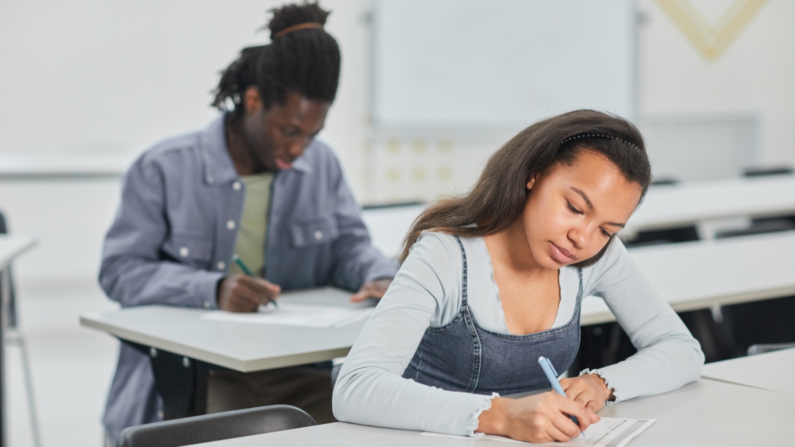 Students sat at desks working.