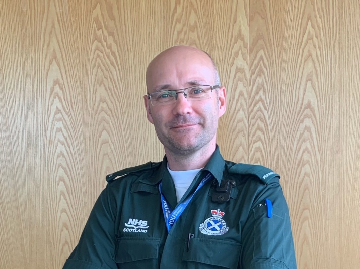 Dr Patrick in his paramedic uniform looking at the camera