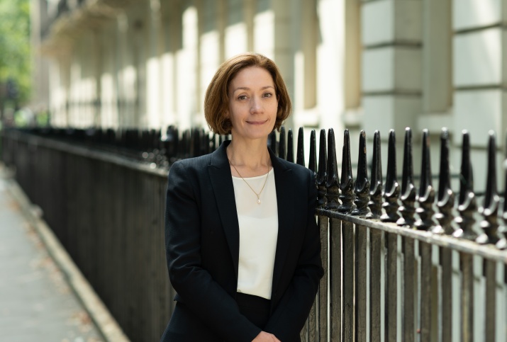 Vivienne Stern stood outside in a street in Bloomsbury on a sunny day, smiling