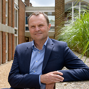 Prodessor Adam Tickell on a sunny university campus