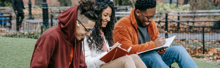 students sitting outside studying