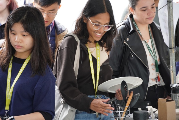 Students at The University of Kent choosing cooking utensils at a foodbank.