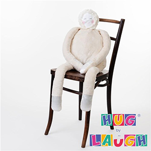 The Hug device sitting on a wooden chair with text in the bottom right corner reading Hug by Laugh