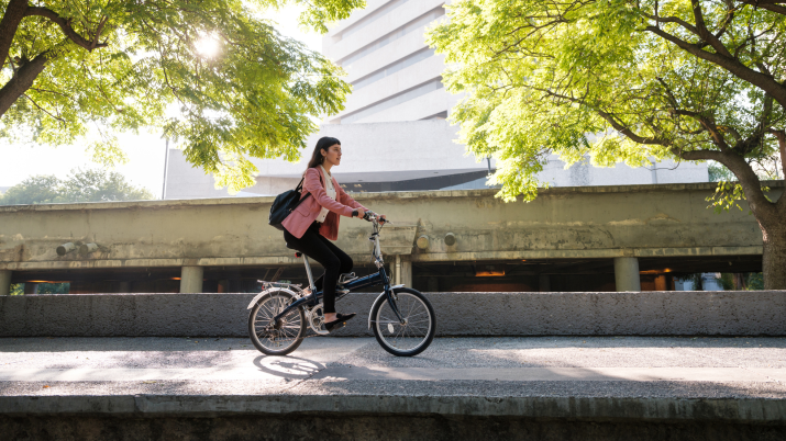 Young woman going to work by bike