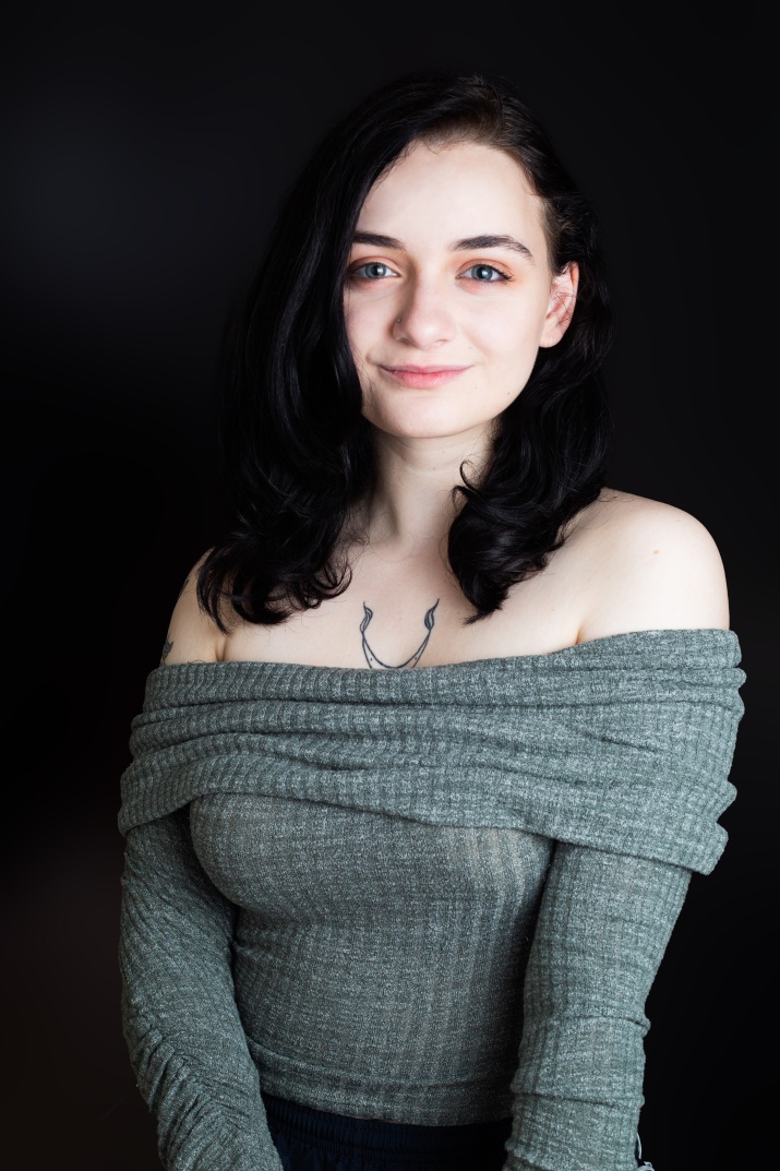 Hunter smiling against a dark background