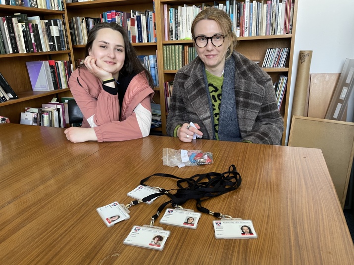 Two visitors with official St Andrews ID cards
