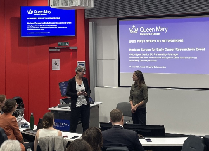 Two speakers address an audience in a lecture theatre at the early-career researcher event. 