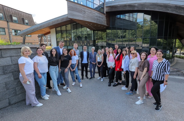 Students on a visit to Durham stand outside of a university building