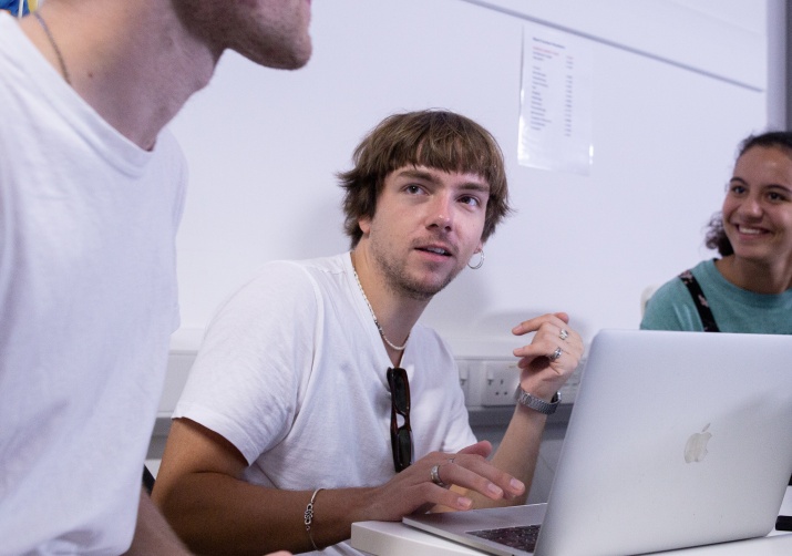 Jack working with friends on his laptop