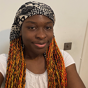 Jessica - My Life SC1ence participant wears a white top and a bandana. Jessica is standing in front of a white background