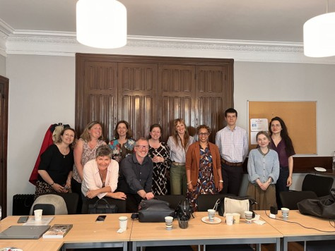 11 people pose for a photograph at a workshop