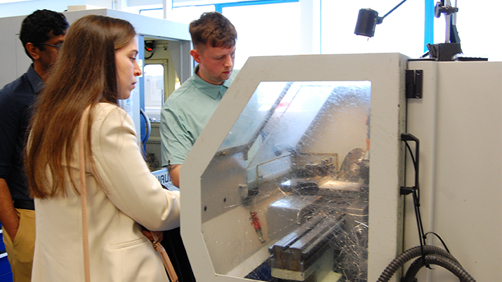 MDMC centre precision engineering launch with two scientists in lab coats.