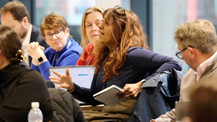 Participants at UUK facilitated Future Jobs roundtable session held at Northumbria University, Newcastle sitting in a large room. 