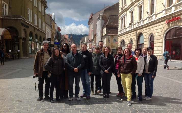 SPAcE team members gather on a cobbled street in Brasov, Romania.