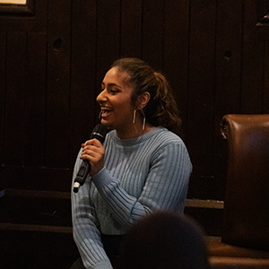 Savanna laughing while she speaks at an event