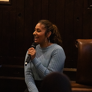 Savanna laughing while she speaks at an event 