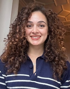 woman with curly brown hair smiling