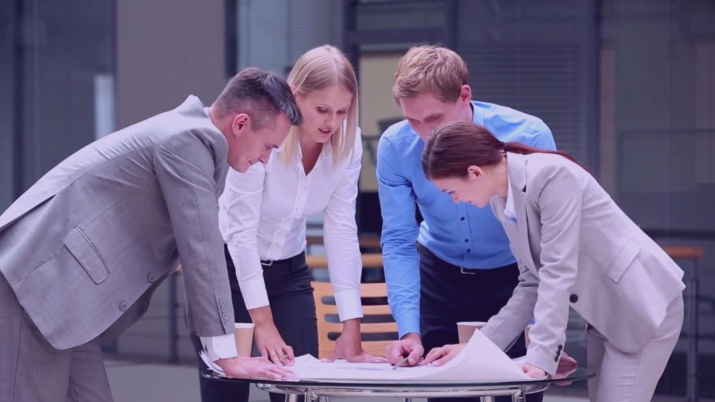 A group of professionals looking over a desk