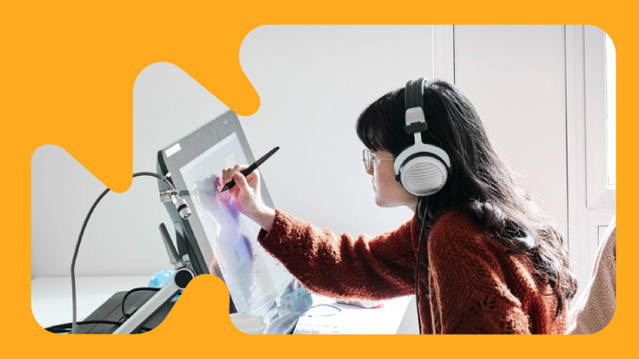 Student creating digital work on a large screen with a stylus