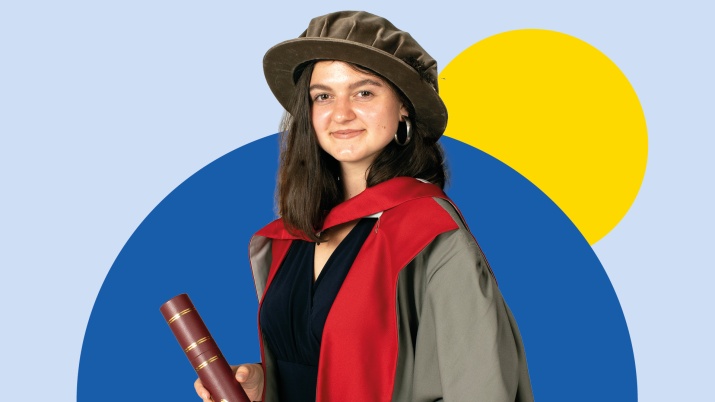 Girl in graduation gown with diploma