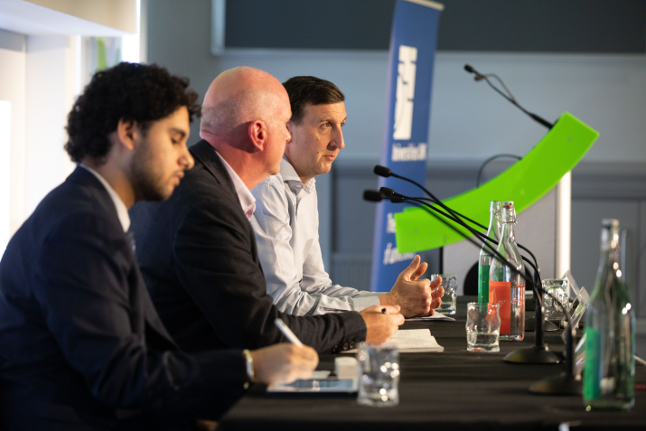 Panel of three listening to audience questions 