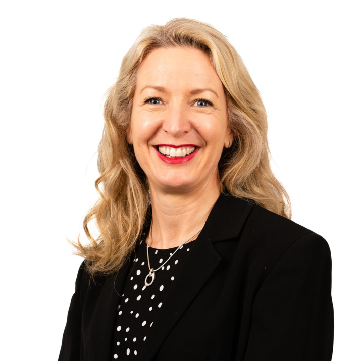 Gayle Ditchburn smiling in front of a plain background