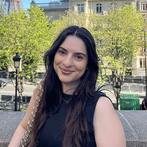 Photo of Hannah Merchant smiling wearing a black top.