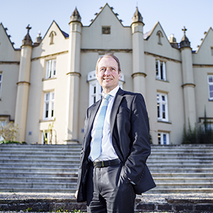 Paul Boyle standing in front of steps leading up to a university building