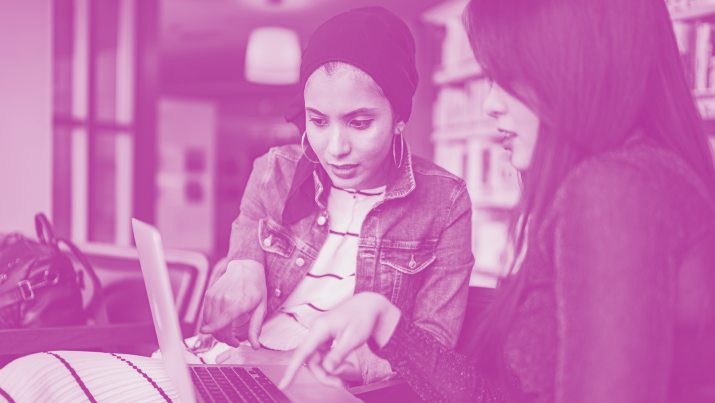 Two women working together on a laptop