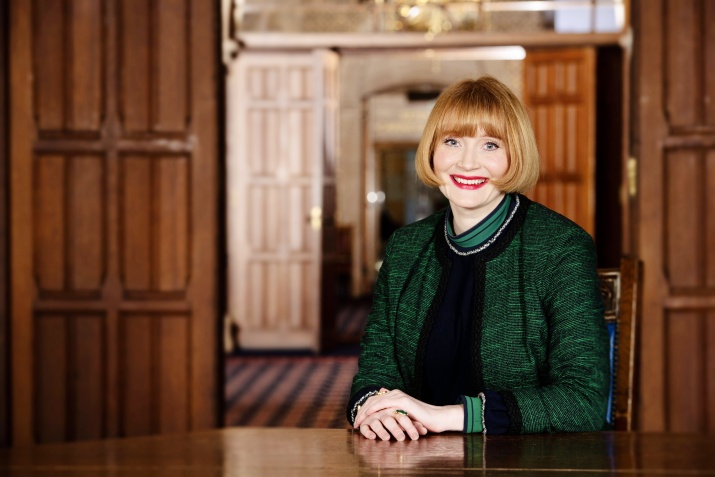 Rachel Sandison sitting in a wood panelled room