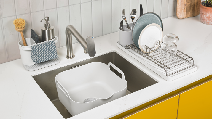 Kitchen sink with Reborn products including a sink caddy and washing up bowl