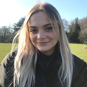 Rosanna Marsh smiling outside in front of a field