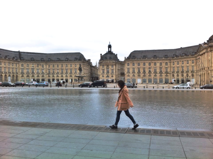 an erasmus student walks along a plaza 