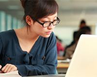 Student studying laptop notes