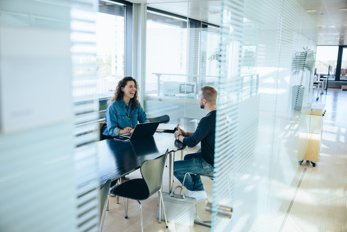 colleagues sit in an bright modern office 